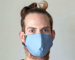 guy wearing green blue reusable face mask