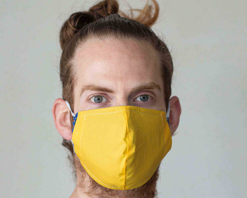 man wearing yellow washable mask with filter